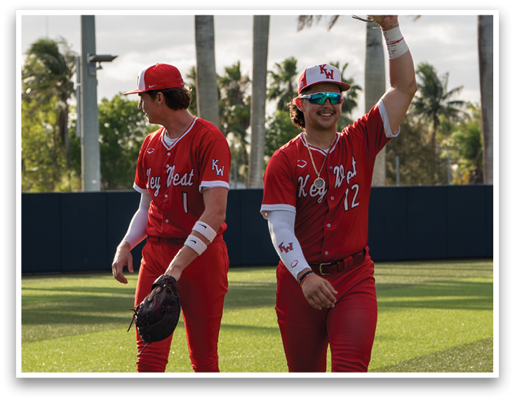 Two baseball players wearing red uniforms. Description generated by AI