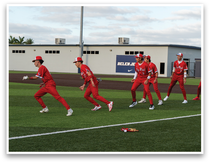 A group of people wearing red uniforms. Description generated by AI