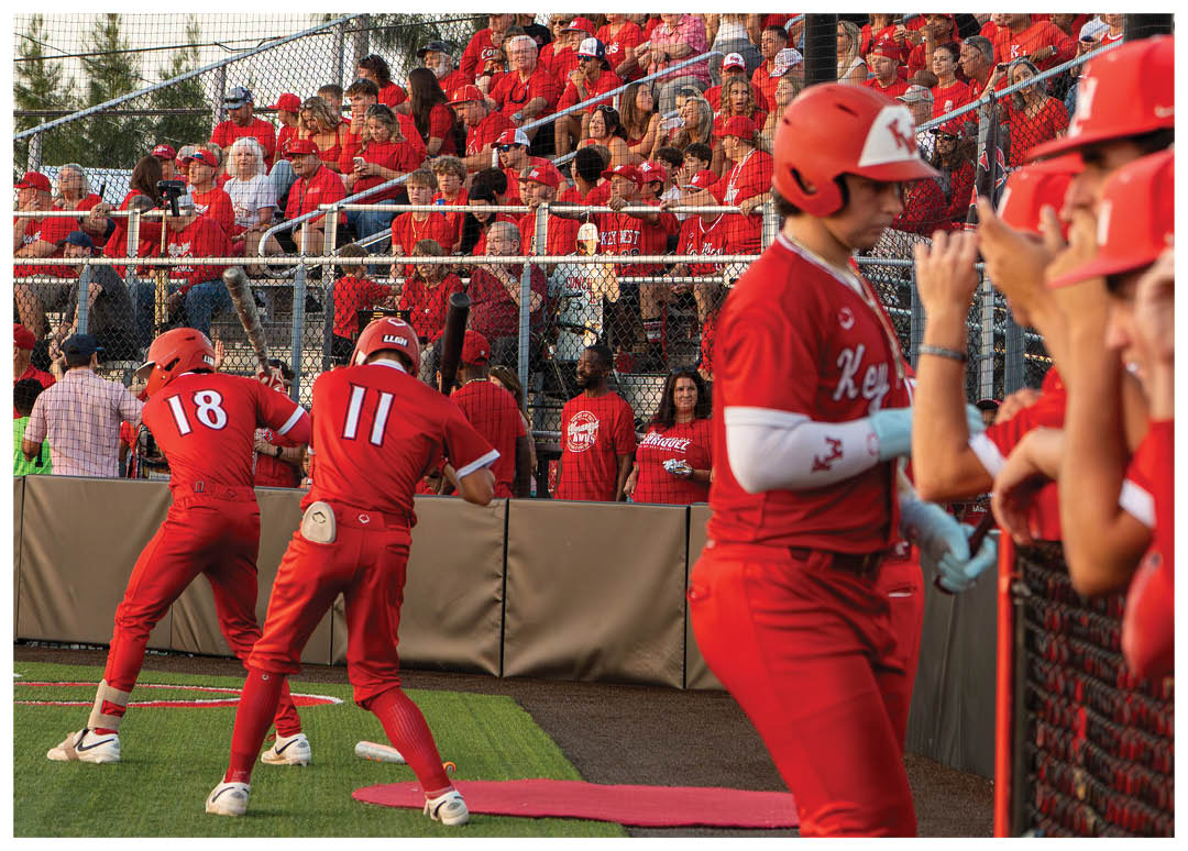 A baseball player wearing a red jersey with the number 11 on it. Description generated by AI