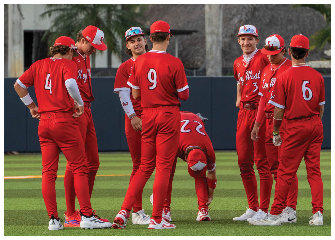 A group of baseball players wearing red uniforms. Description generated by AI