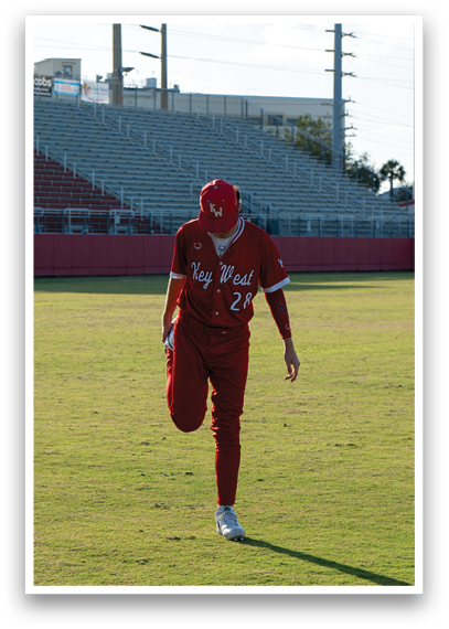 A baseball player wearing a red and white uniform. Description generated by AI