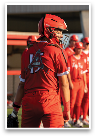 A baseball player wearing a red jersey with the number 14 on it. Description generated by AI