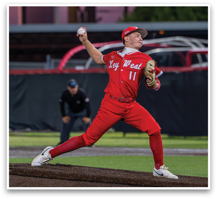 A man in a red baseball uniform is pitching a ball. Description generated by AI