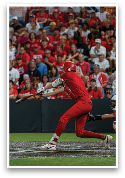 A baseball player in a red shirt and red pants is swinging a bat. Description generated by AI