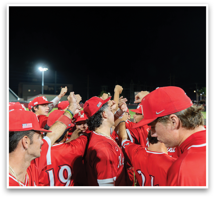 A group of baseball players wearing red hats and red shirts. Description generated by AI