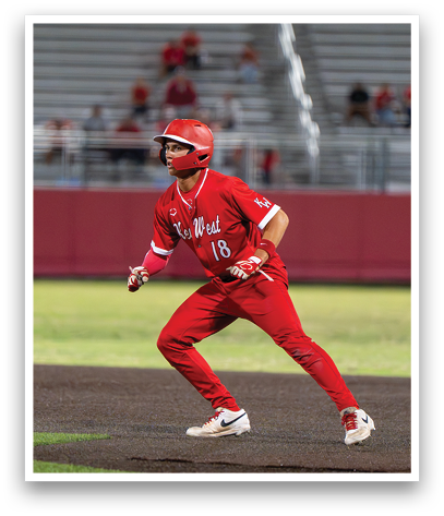 A baseball player in a red uniform is running to first base. Description generated by AI