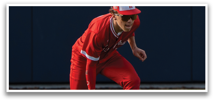A baseball player in a red uniform is running to catch a ball. Description generated by AI
