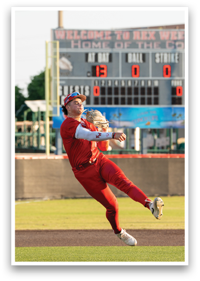A baseball player wearing a red jersey and white pants catching a ball. Description generated by AI