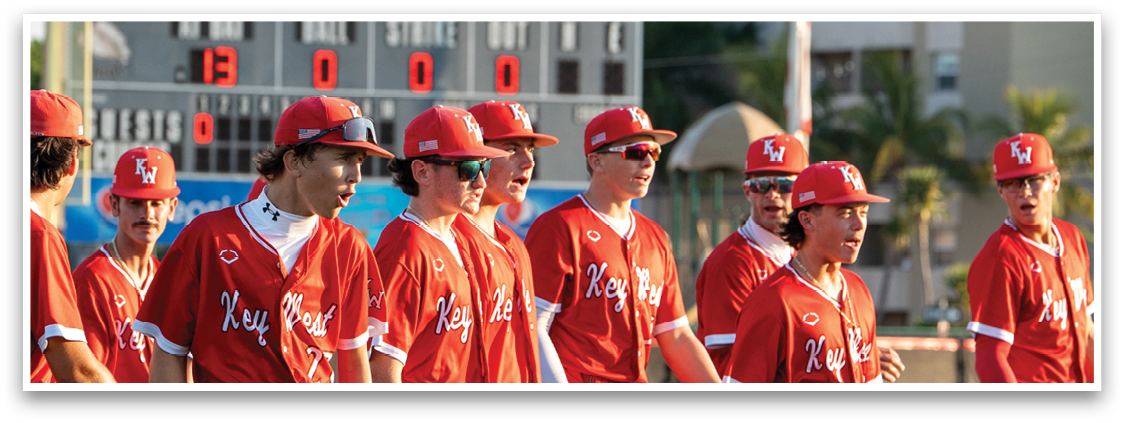 A group of baseball players wearing red uniforms. Description generated by AI