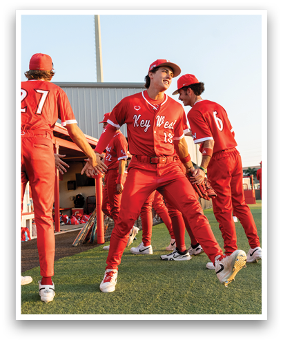 A group of people wearing red shirts and red pants. Description generated by AI