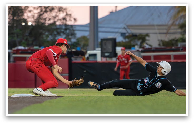A baseball player slides into a base. Description generated by AI