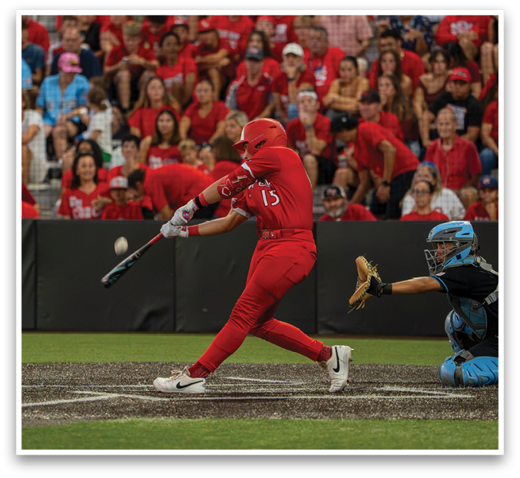 A baseball player in a red shirt and red pants swinging a bat. Description generated by AI