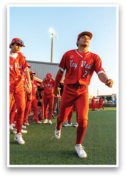 A group of people wearing red jerseys. Description generated by AI