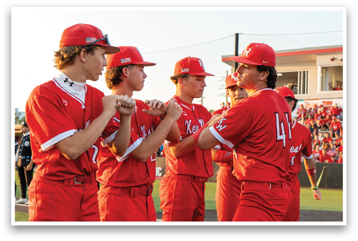 A group of baseball players wearing red uniforms. Description generated by AI