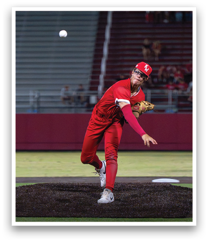 A baseball player in a red uniform is pitching a ball. Description generated by AI