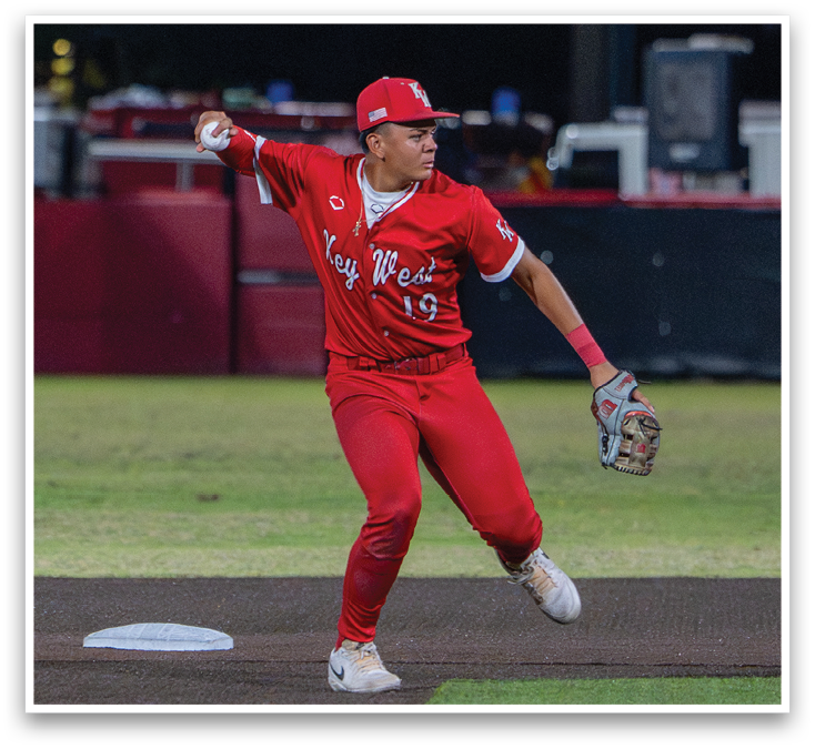 A baseball player in a red uniform is running towards a base. Description generated by AI