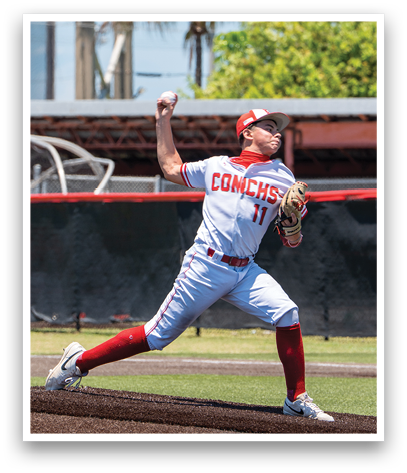 A baseball player in a white and red uniform is pitching a ball. Description generated by AI