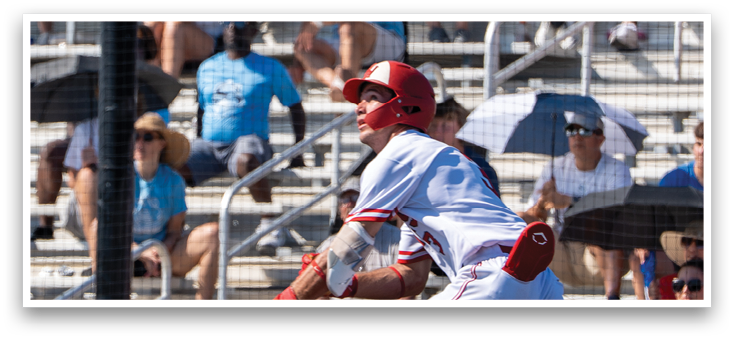 A baseball player running with a bat. Description generated by AI