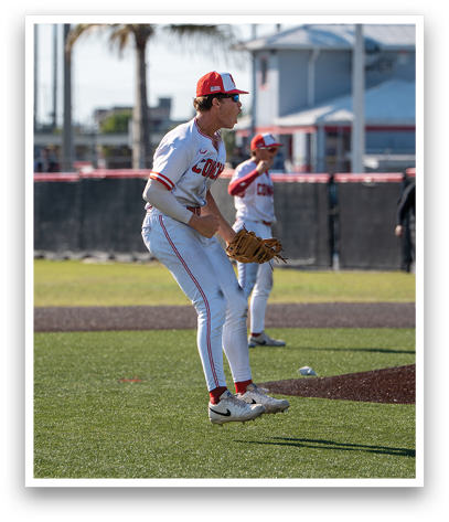 A baseball player wearing a red and white uniform and a red hat. Description generated by AI