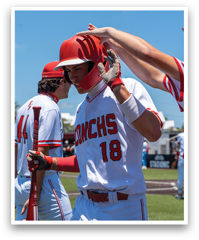 A baseball player wearing a red helmet and a white jersey with the number 18 on it. Description generated by AI