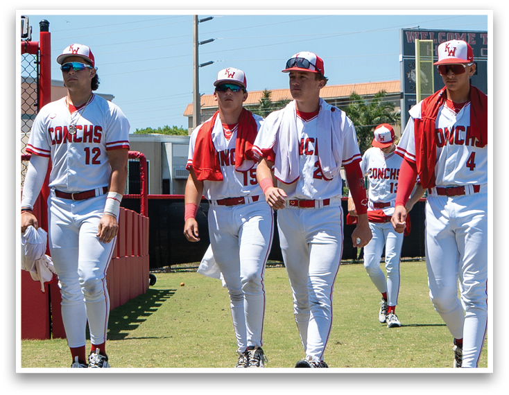 A group of baseball players walking on a field. Description generated by AI
