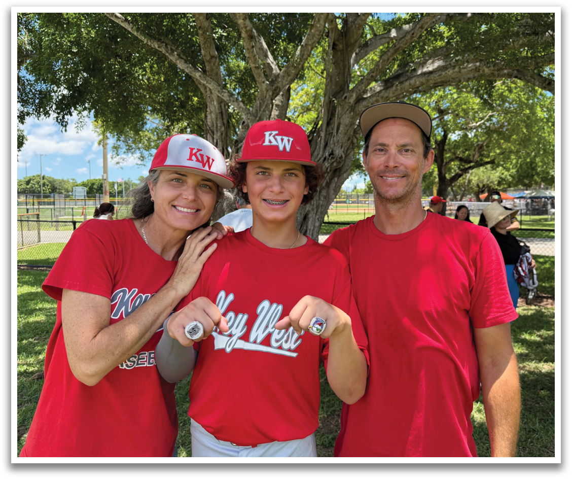 A man, woman, and boy are standing together in a park, posing for a picture. The boy is wearing a red shirt and a red hat. AI generated content