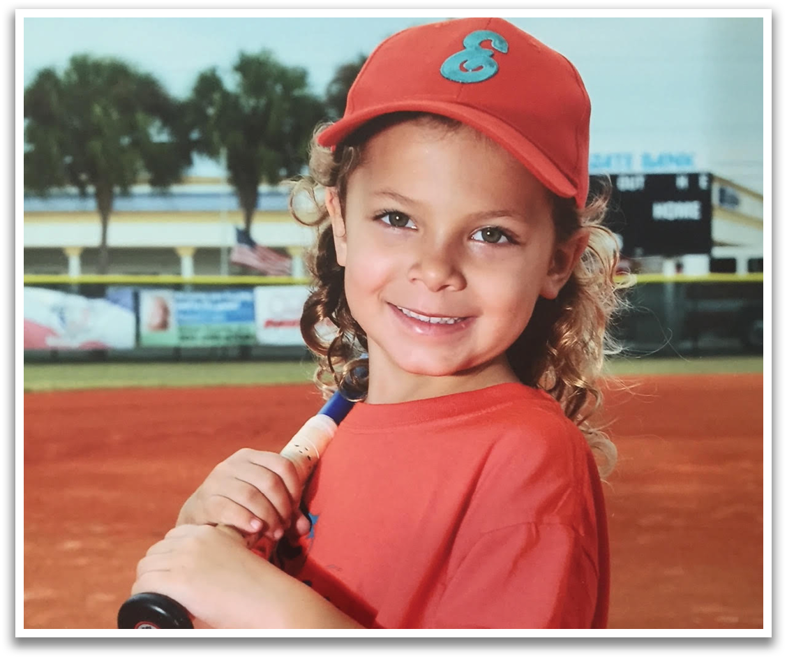 A young girl wearing a baseball uniform and holding a bat. AI generated content