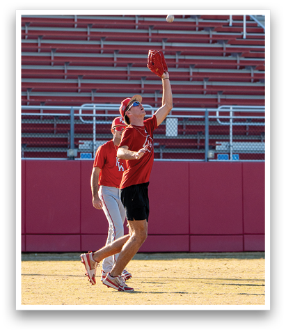Two men playing baseball, one catching a ball in a red glove. AI generated content