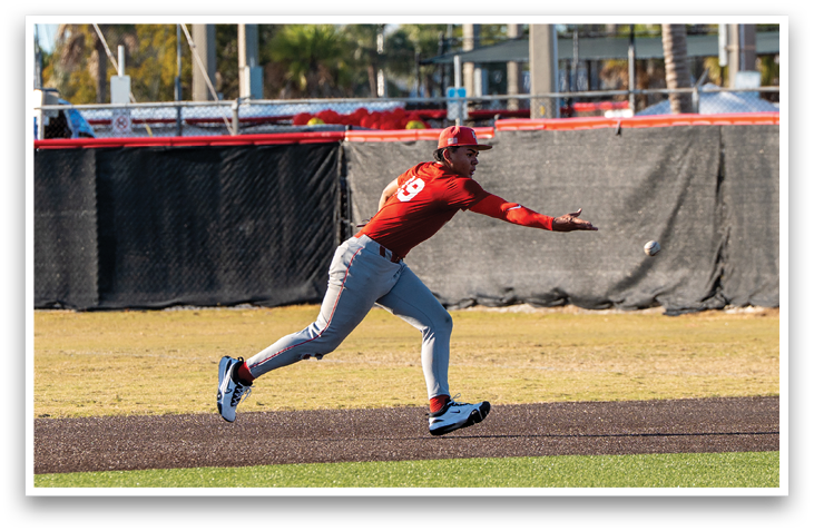 A baseball player in a red shirt and grey pants is throwing a ball. AI generated content