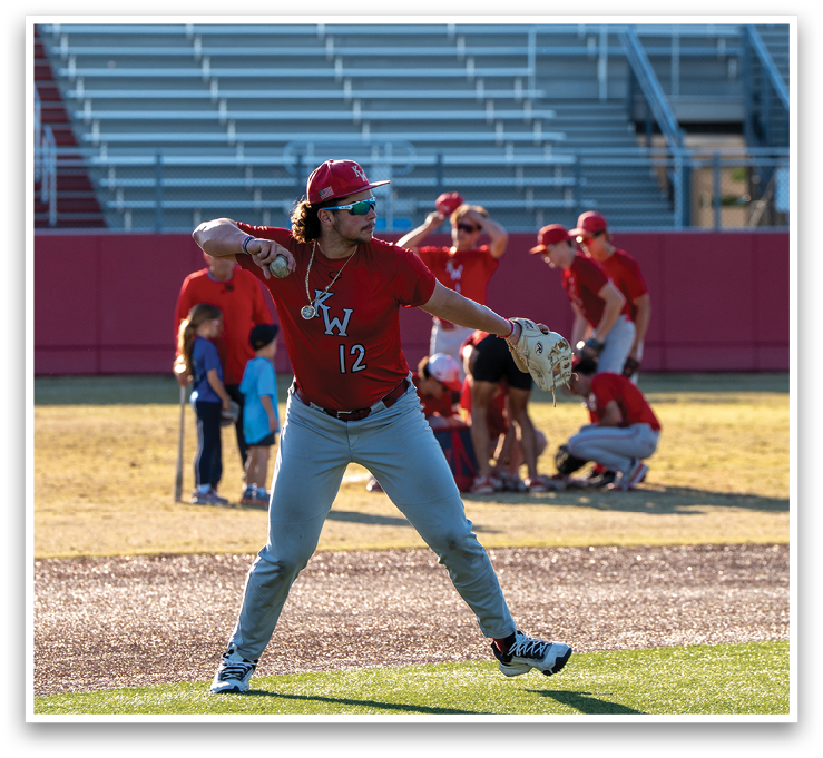 A baseball player in a red shirt and grey pants is throwing a ball on a field. AI generated content