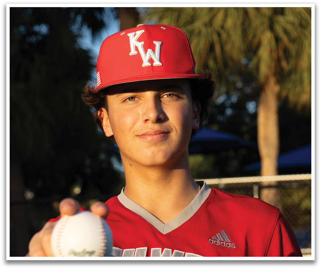A young man wearing a red and white shirt holds a baseball in his hand. AI generated content