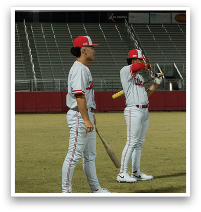 Two baseball players standing on a field, each holding a bat. AI generated content
