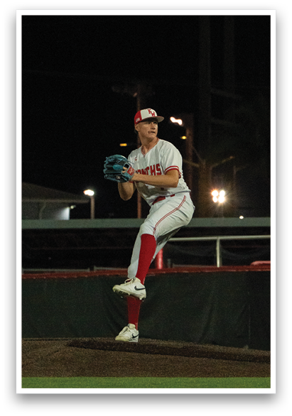 A baseball player in a white uniform is pitching a ball on a field. AI generated content