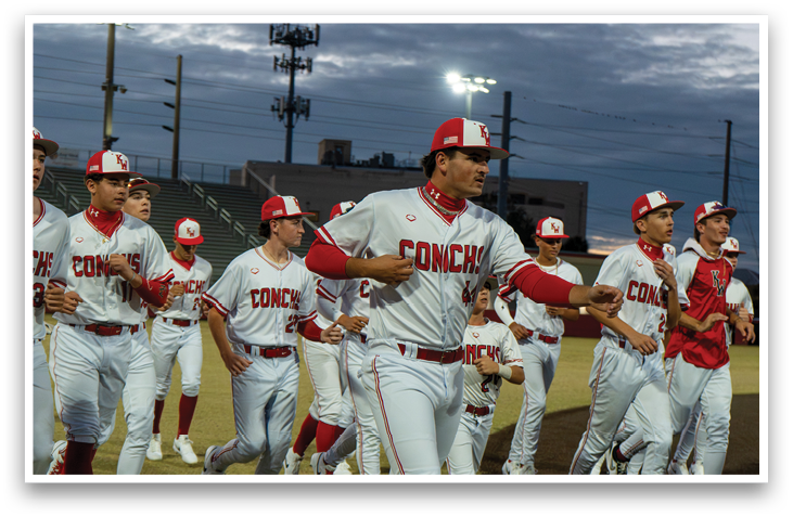 A group of baseball players wearing red and white uniforms are walking on a field. AI generated content