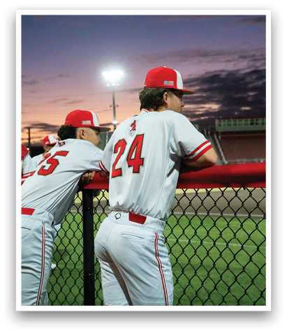 Two baseball players wearing red and white uniforms are leaning on a fence. AI generated content