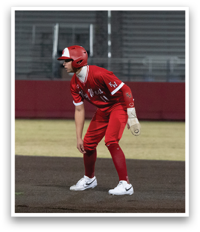 A baseball player in a red uniform is standing on the field, holding a bat and getting ready to hit the ball. AI generated content