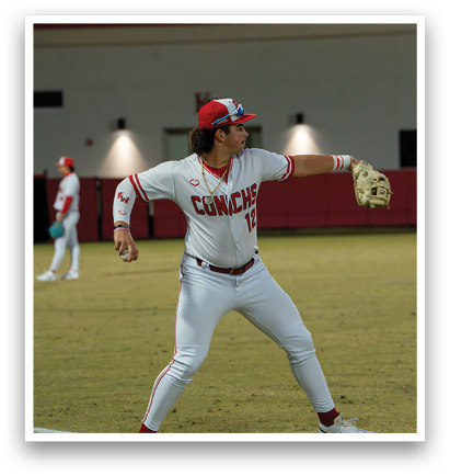 A baseball player in a white uniform is throwing a ball on a field. AI generated content