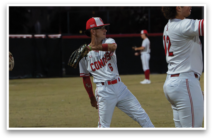 Baseball players wearing red and white uniforms are standing on a field. AI generated content