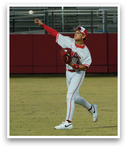 A baseball player in a white uniform is throwing a ball. AI generated content