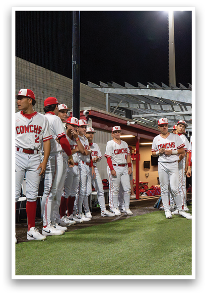 A group of baseball players wearing red and white uniforms are standing on a field. AI generated content