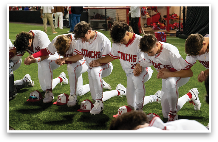 A group of baseball players are praying on the field. AI generated content