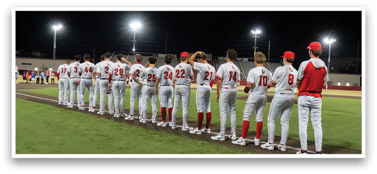 Baseball players in uniforms standing on a field at night. AI generated content