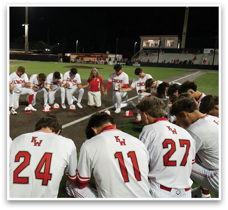 Baseball players praying on the field. AI generated content