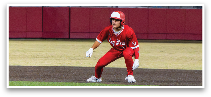 A baseball player in a red uniform is crouching on the field, ready to catch a ball. AI generated content