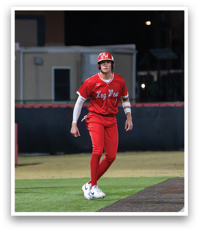 A baseball player wearing a red jersey and red pants is walking on the field. AI generated content