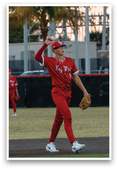 A baseball player in a red jersey is holding a baseball glove and preparing to catch a ball. AI generated content
