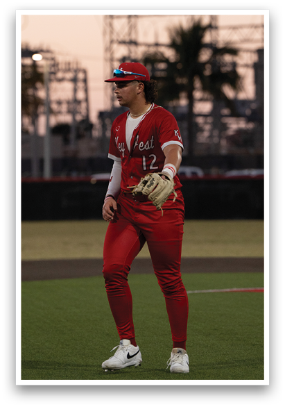 A baseball player wearing a red jersey and a white hat stands on a field. AI generated content