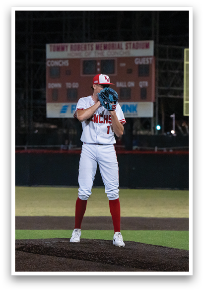 A baseball player in a white uniform is standing on the field, holding a baseball glove and preparing to catch a ball. AI generated content