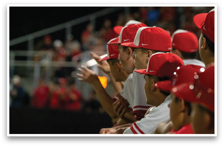 A group of baseball players wearing red hats and white uniforms are standing on a field. AI generated content