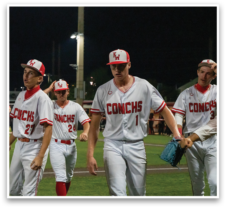 A group of baseball players wearing white uniforms and red caps. AI generated content